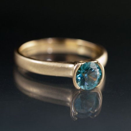Nodeform Weddings Blue Zircon Half Bezel Solitaire Engagement Ring in Yellow Gold
